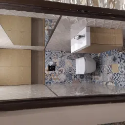 Nowoczesna łazienka z drewnianą szafką pod umywalką, białą umywalką i toaletą, podłoga i ściana wyłożone płytkami w patchworkowy wzór, lustro na ścianie.