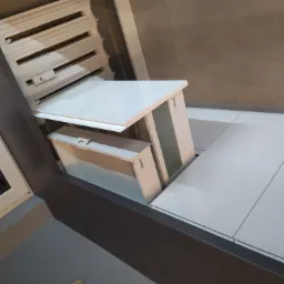 Wysuwany, biały blat roboczy z mechanizmem Blum, zamontowany przy oknie i grzejniku, widok z dołu.