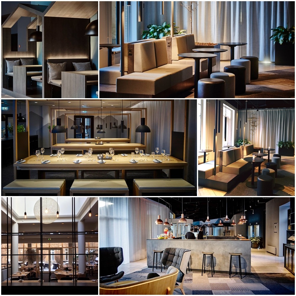 Wnętrze restauracji z różnymi strefami siedzącymi: drewniane loże z poduszkami, długi stół z zastawą, bar z hokerami i fotelami, oświetlenie punktowe i wiszące lampy.
