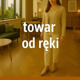 Lammos Floor - Jasna podłoga drewniana ułożona w jodełkę francuską, w tle kobieta i meble w salonie. Na zdjęciu widnieje napis „towar od ręki”.