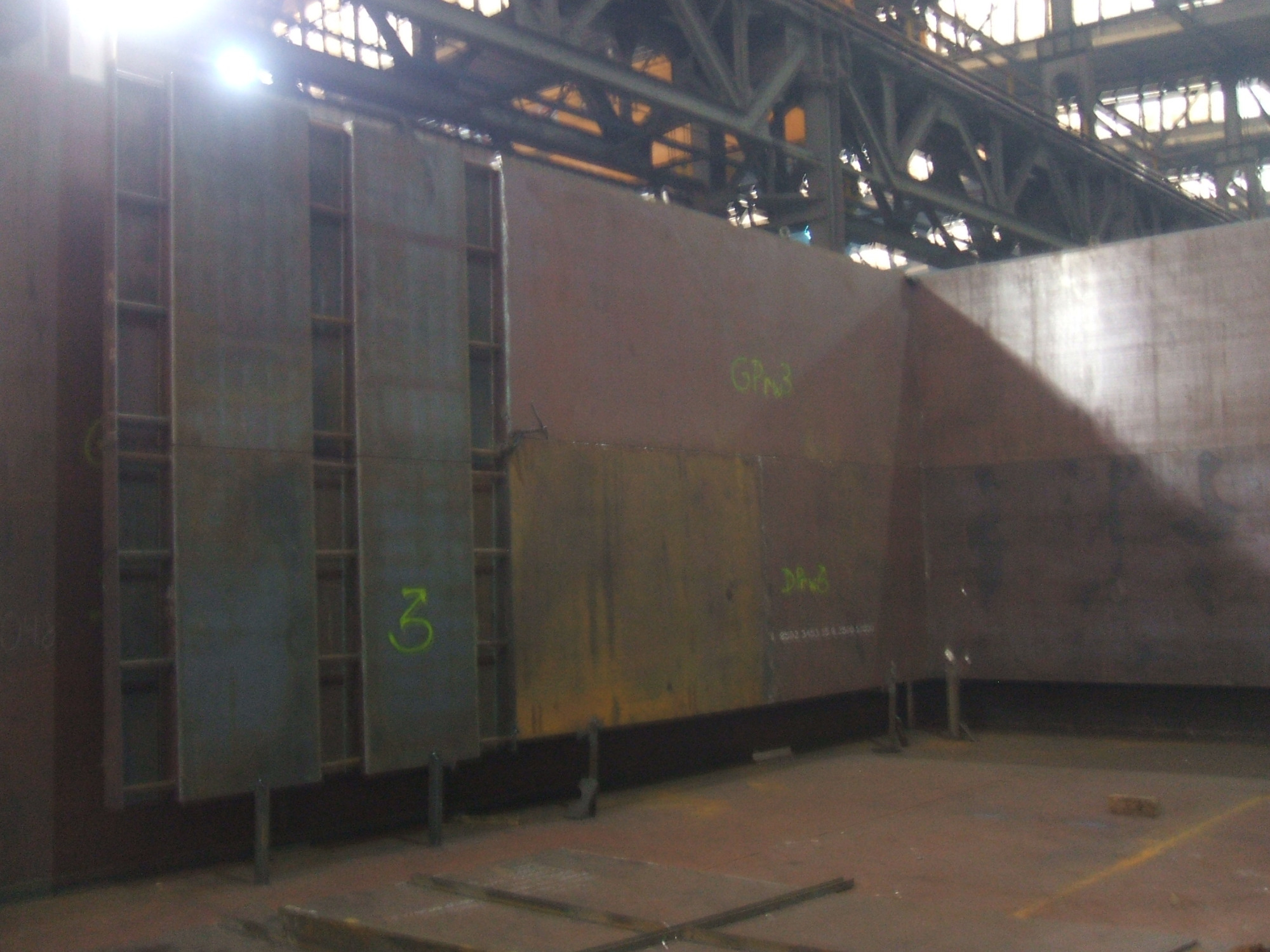 Konstrukcja stalowa w hali produkcyjnej w Malborku, widoczne elementy spawane i oznaczenia farbą.