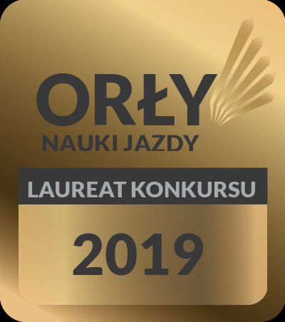 Złota plakietka z napisem 'Orły Nauki Jazdy', 'Laureat Konkursu 2019' i graficznym symbolem promieni.