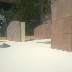 Zakład remontowo-budowlany - Montaż płytek imitujących kamień na konstrukcji tarasu na dachu budynku, widoczne elementy izolacyjne i przygotowanie do dalszych prac wykończeniowych.