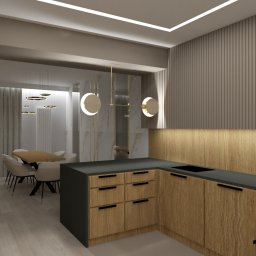 Venosfera Anna Dąbrowska - Wizualizacja nowoczesnej kuchni z drewnianymi szafkami i czarnym blatem, widoczny stół jadalny z krzesłami w tle, oświetlenie LED w suficie i dekoracyjne lampy nad stołem.