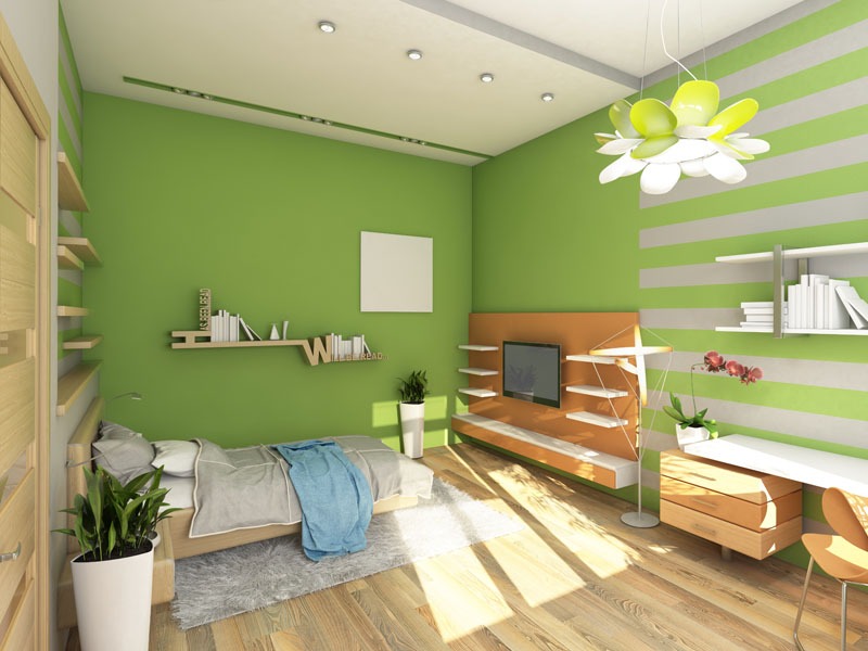 Wnętrze pokoju z zielonymi ścianami, drewnianą podłogą i designerską lampą w kształcie kwiatu, ukazujące aranżację z półkami na książki i telewizorem.