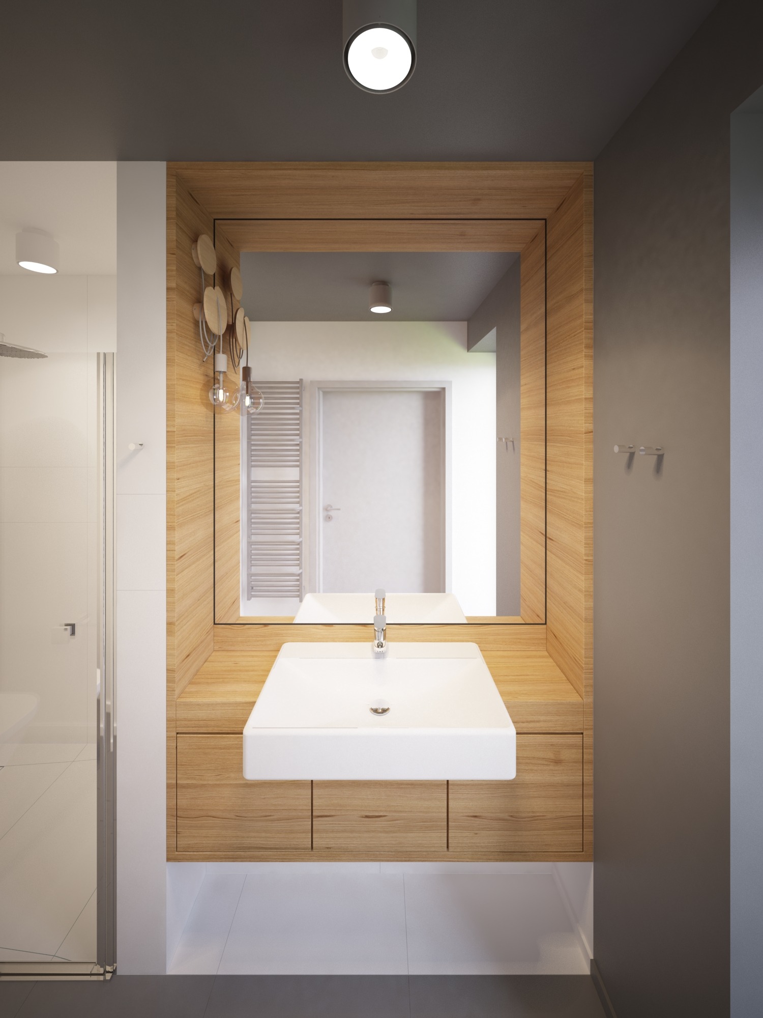 Nowoczesna łazienka z drewnianą zabudową umywalki, prostokątną białą umywalką nablatową i dużym lustrem w drewnianej ramie. W tle widoczny grzejnik drabinkowy i kabina prysznicowa.