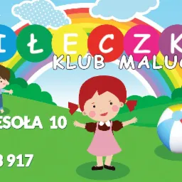 Kolorowa grafika reklamowa z rysunkowymi dziećmi, piłką plażową i tęczą, promująca klub malucha 'Piłeczka' w Tuchomiu, adres Wesola 10, dla dzieci w wieku 1-3 lat, z podanym numerem telefonu.