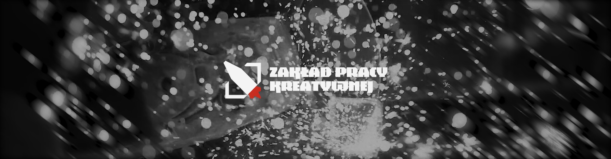 Logo firmy Zakład Pracy Kreatywnej na abstrakcyjnym, rozmazanym tle z efektem bokeh.