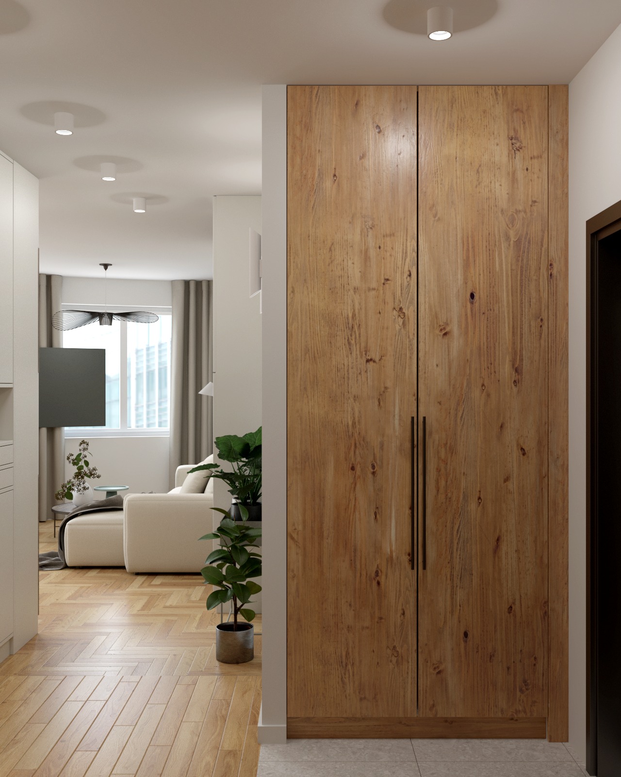 Drewniana szafa w przedpokoju z widokiem na salon z beżową sofą, parkietem w jodełkę i dekoracyjną lampą sufitową.