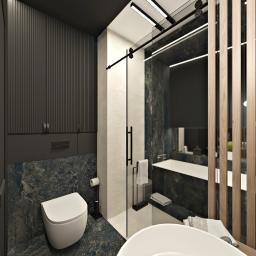 Żeromska Projektowanie wnętrz - Nowoczesna łazienka z kabiną prysznicową typu walk-in, toaleta podwieszana na tle ściany z ciemnego marmuru, oświetlenie LED i drewniane panele dekoracyjne.