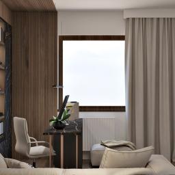 Żeromska Projektowanie wnętrz - Nowoczesny pokój dzienny z kącikiem do pracy: biurko z marmurowym blatem, krzesło obrotowe, regał z oświetleniem, sofa z beżowymi poduszkami i telewizor na ścianie.