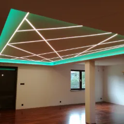 Nowoczesny sufit podwieszany z zielonym podświetleniem LED i geometrycznym układem białych linii świetlnych w przestronnym wnętrzu z parkietem i oknem.