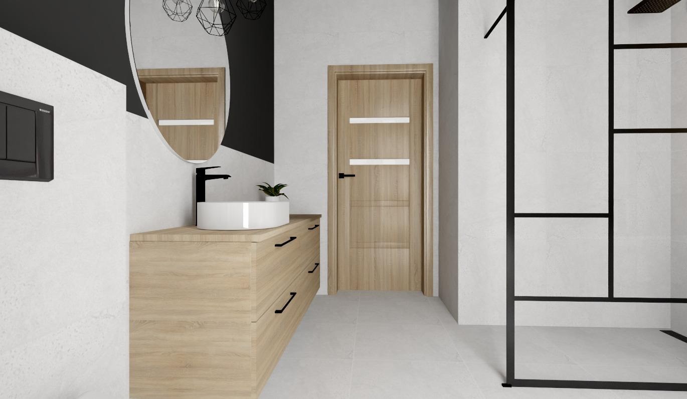 Nowoczesna łazienka z drewnianą szafką pod umywalką, okrągłym lustrem i kabiną prysznicową z czarnymi profilami. Minimalistyczny design, jasne płytki.