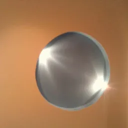 Okrągły otwór w pomarańczowej ścianie, oświetlony od wewnątrz, z fragmentem łuku architektonicznego po prawej stronie.