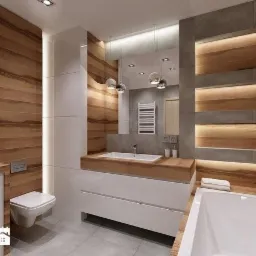 Nowoczesna łazienka z drewnianymi panelami, białymi szafkami pod umywalką i podświetlanymi p&oacute;łkami, akcentowana wiszącymi lampami i szarą płytką.