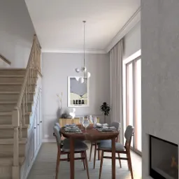 Jadalnia w jasnych barwach z okrągłym stołem nakrytym dla czterech os&oacute;b, drewnianymi krzesłami z szarymi siedziskami, kominkiem w ścianie i schodami z jasnego drewna po lewej stronie.