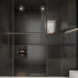 Minimalistyczna, ciemna kuchnia w Komnach z piekarnikiem TEKA, podświetlanymi półkami i dekoracyjnym obrazkiem w złotej ramie, widoczna przez szklane drzwi.