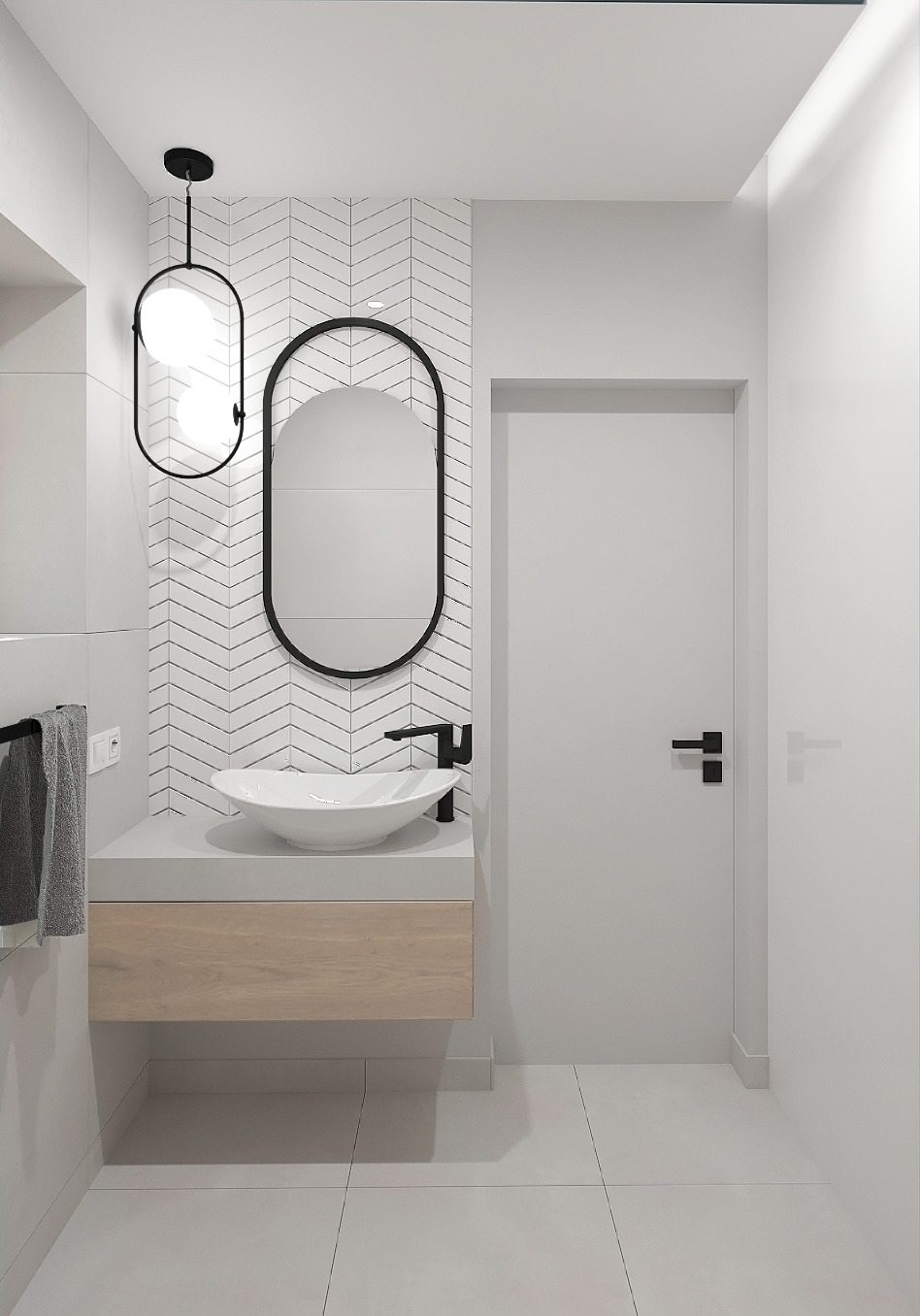 Minimalistyczna łazienka z owalnym lustrem w czarnej ramie, wiszącą szafką z drewnianym frontem i białą umywalką w kształcie misy, oświetlona lampą z dwoma kulami, na tle ściany wyłożonej białymi...