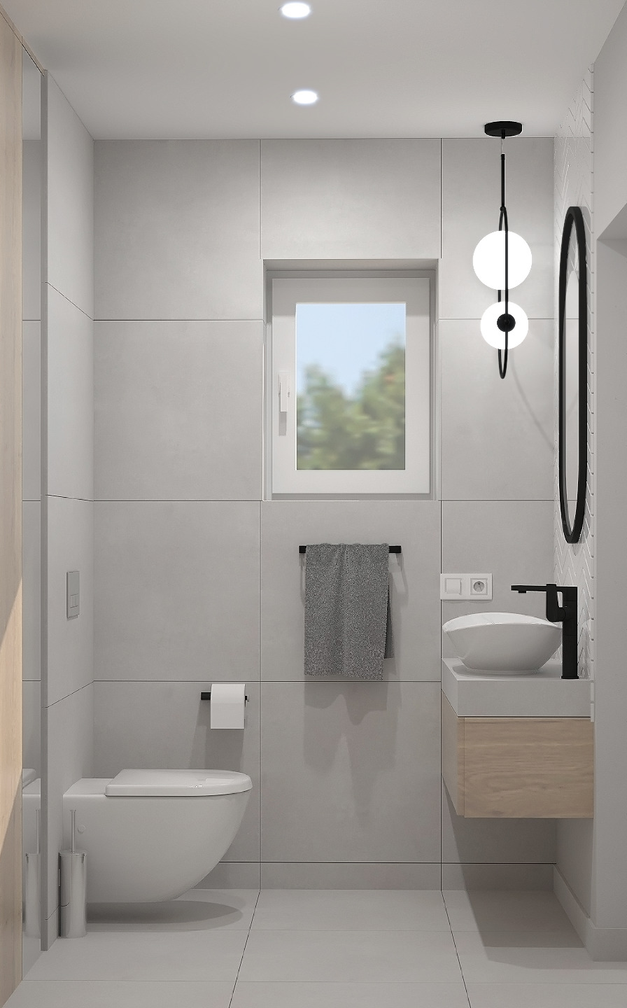 Minimalistyczna łazienka w odcieniach szarości, z wiszącą toaletą, umywalką nablatową na drewnianej szafce i okrągłym lustrem w czarnej ramie, oświetlona nowoczesną lampą z dwoma kulami.