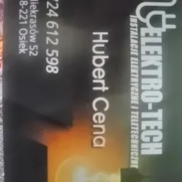 Wizytówka firmy Elektro-Tech z adresem i numerem telefonu, oferującej instalacje elektryczne i teletechniczne, z grafiką żarówki w dolnej części.