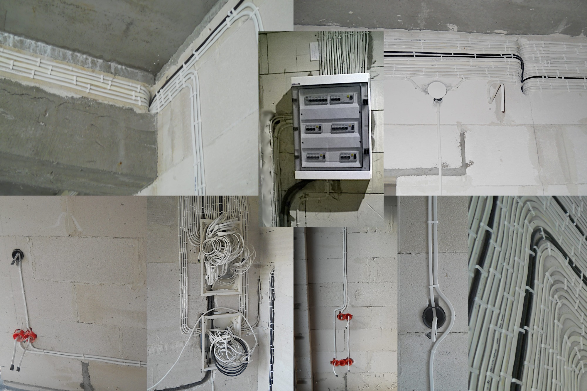 Rozbudowana instalacja elektryczna w budynku w stanie surowym: białe rurki prowadzące przewody, rozdzielnia elektryczna na ścianie z betonu komórkowego.