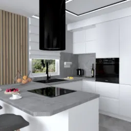 Nowoczesna, minimalistyczna kuchnia z białymi szafkami, szarym blatem wyspy, czarnym okapem i drewnianymi lamelami na ścianie, uzupełniona owocami, ciastkami i kawą.