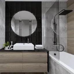Nowoczesna łazienka z okrągłym lustrem podświetlanym od tyłu, czarną armaturą, białymi sanitariatami i drewnopodobnymi płytkami na ścianie.