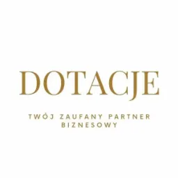 Logo z napisem 'DOTACJE' oraz hasłem 'TWÓJ ZAUFANY PARTNER BIZNESOWY' w kolorze złotym na białym tle.