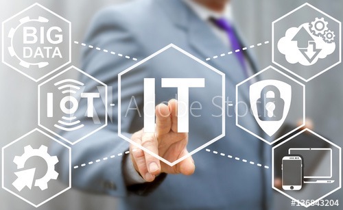 Biznesmen w szarym garniturze dotyka wirtualnego ekranu z ikonami: Big Data, IoT, IT, chmura, bezpieczeństwo i urządzenia mobilne.