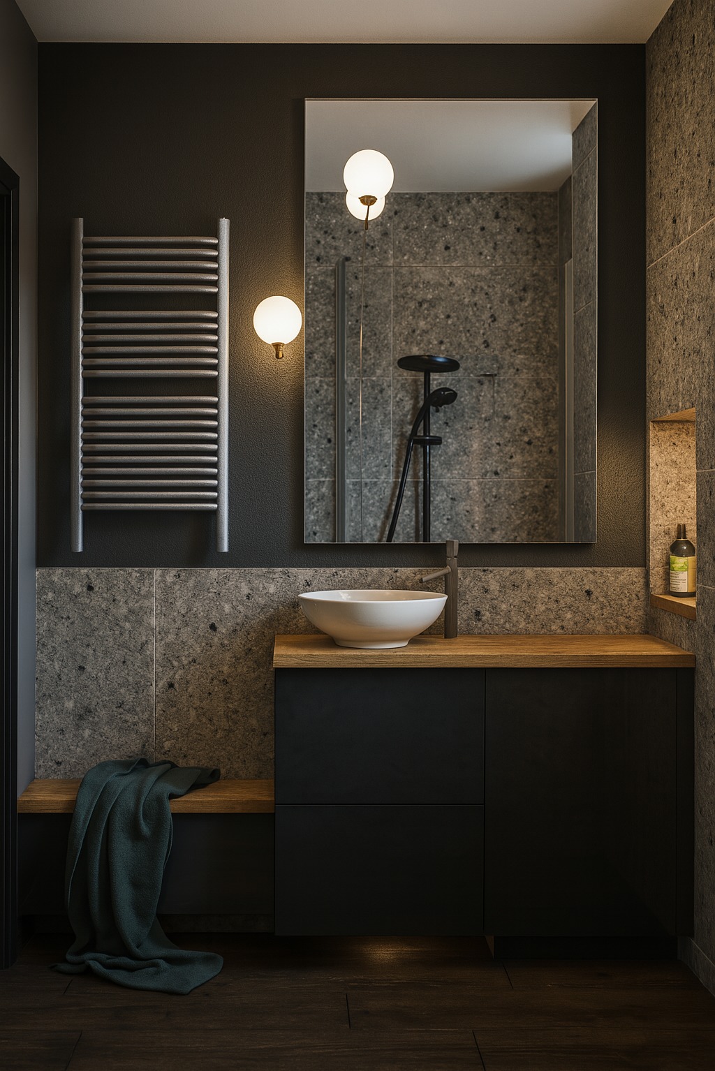 Nowoczesna łazienka w ciemnych barwach z drewnianymi akcentami. Umywalka nablatowa, grzejnik drabinkowy, lustro odbijające kabinę prysznicową. Minimalistyczny design.