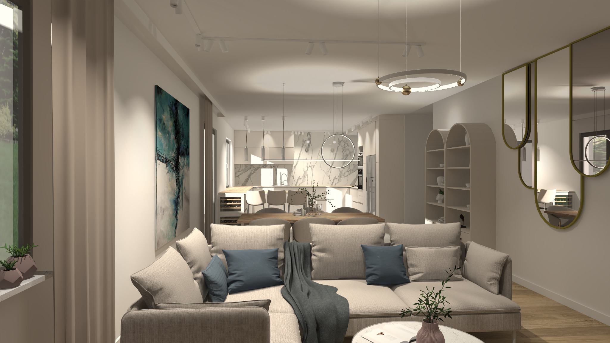 Jasny salon z beżową sofą, niebieskimi poduszkami i szarym pledem, otwarta kuchnia z marmurowym blatem w tle, okrągła lampa wisząca i lustra w złotych ramach.