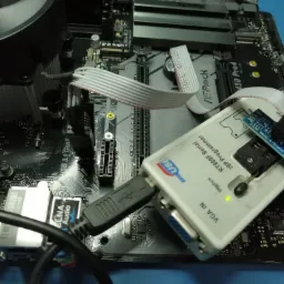 Programator RT809F Serial ISP podłączony przez USB do płyty głównej ASRock 450 Pro4, z podpiętym układem scalonym SOP16/8-DIPS REU3, sygnalizujący status diodą LED.