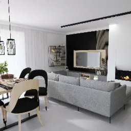 Jasne wnętrze z jadalnią i salonem: stół z nakryciem, szary narożnik, telewizor na czarnej ścianie z drewnianymi listwami i kominek obok ściany z ułożonym drewnem.