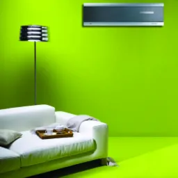 Nowoczesny, srebrny klimatyzator LG zamontowany na jaskrawozielonej ścianie nad białą sofą z poduszką i tacą z filiżanką i imbrykiem, oświetlony lampą podłogową.