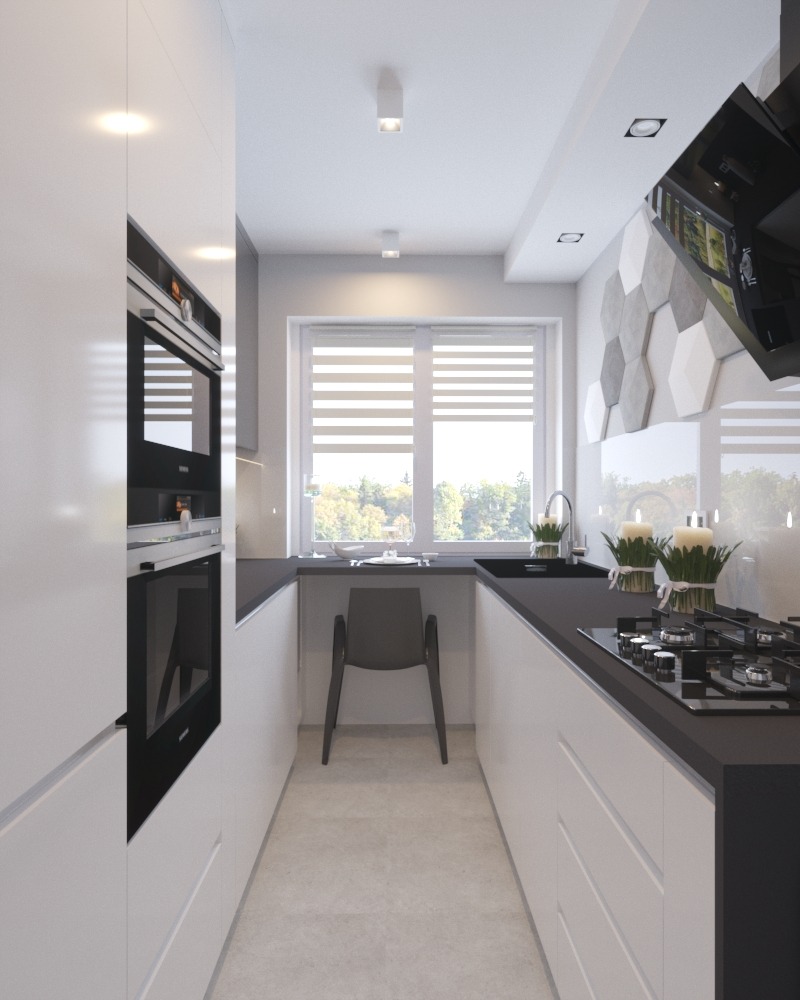 Wąska, nowoczesna kuchnia we Wrocławiu z białymi szafkami, czarnym blatem i sprzętem AGD, widok na okno z żaluzjami i krzesło pod blatem, dekoracyjne heksagony na ścianie.