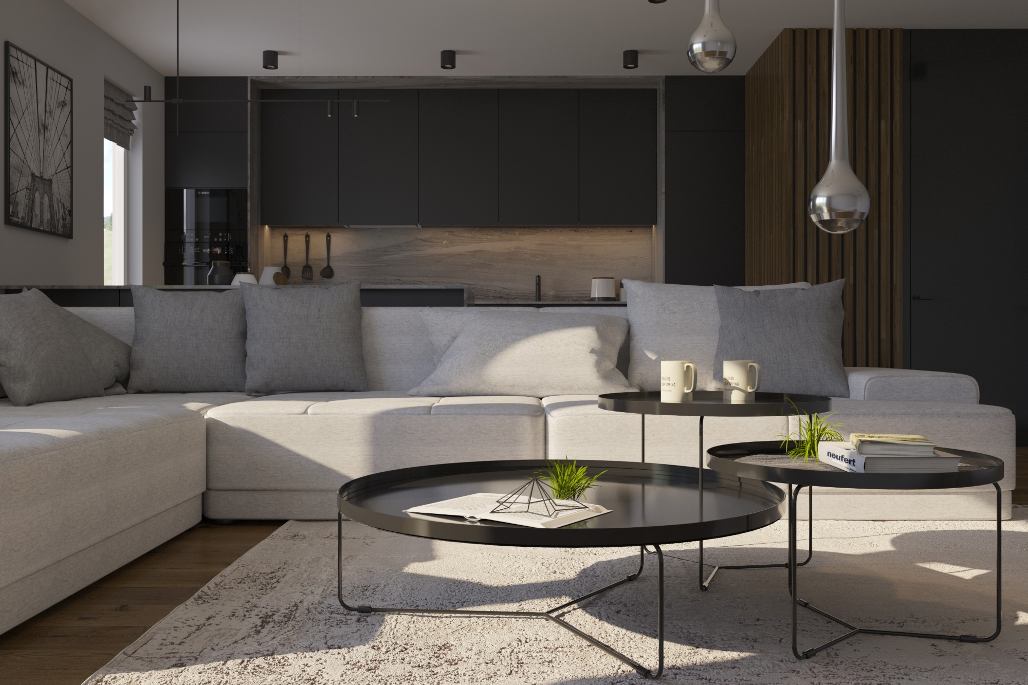 Jasnoszara sofa narożna z szarymi poduszkami w nowoczesnym salonie z ciemnymi meblami kuchennymi w tle i dwoma czarnymi stolikami kawowymi o różnych wysokościach.