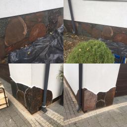 Truszkowski - Wykończenie elewacji budynku kamieniem naturalnym w różnych odcieniach brązu i szarości, widoczne elementy orynnowania i fragment chodnika z kostki.