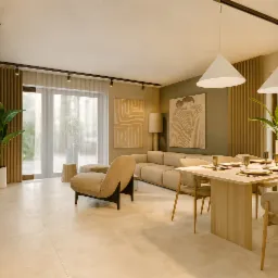 Neutralna aranżacja wnętrza: beżowa sofa, stół z nakryciem, krzesła i rośliny w donicach. Minimalistyczne obrazy na ścianie, lampy wiszące i oświetlenie szynowe.