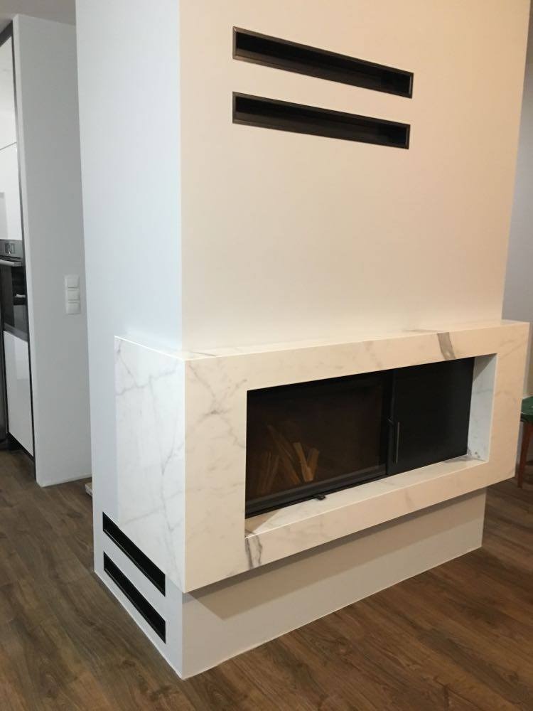 Nowoczesny, zabudowany w białej obudowie z marmurowym wzorem, z poziomymi, czarnymi wlotami wentylacyjnymi na górze i dole obudowy.