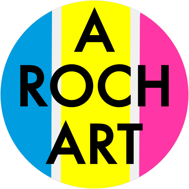 Okrągłe logo 'A ROCH ART' z pionowymi pasami w kolorach niebieskim, żółtym i różowym, oddzielonymi wąskim białym paskiem.