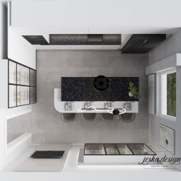 JESKA.DESIGN Magdalena Jerzewska - Widok z góry na minimalistyczną kuchnię z wyspą z czarnym blatem, czterema krzesłami, szarą podłogą, oświetleniem LED nad wyspą i zabudową kuchenną w bieli i czerni. Widoczne logo projektanta...