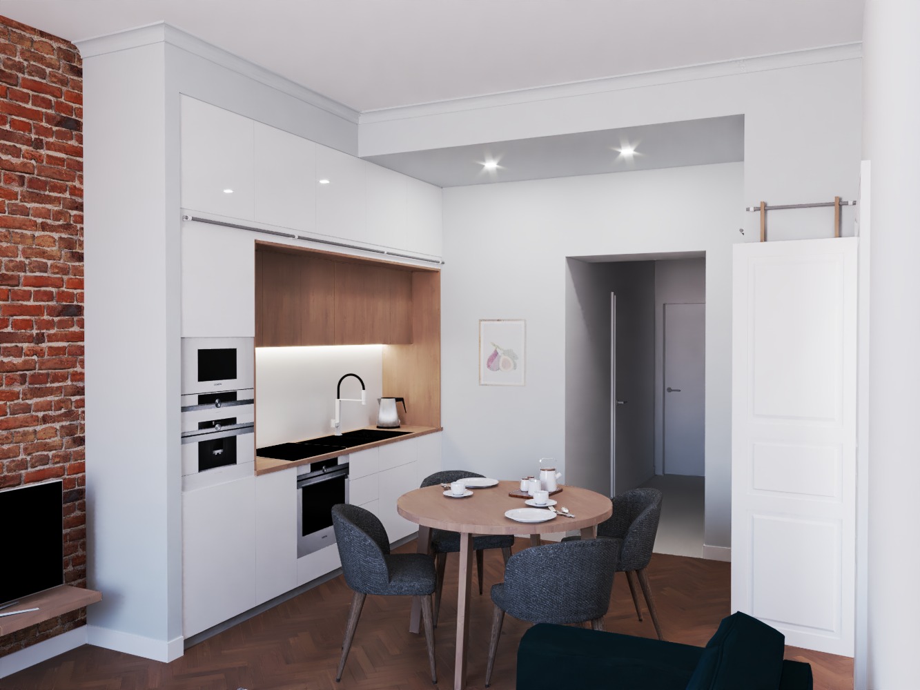 Wnętrze mieszkania z nowoczesną, białą zabudową kuchenną, drewnianym blatem, ceglaną ścianą, okrągłym stołem jadalnym i szarymi krzesłami.