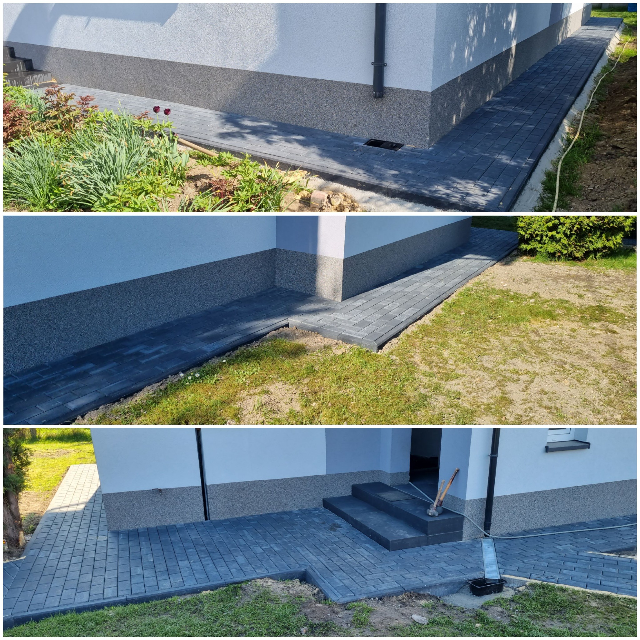 Nowo ułożona, ciemnoszara kostka brukowa tworząca ścieżkę wokół domu z szarą elewacją, widoczna rabata z roślinami i fragment trawnika.