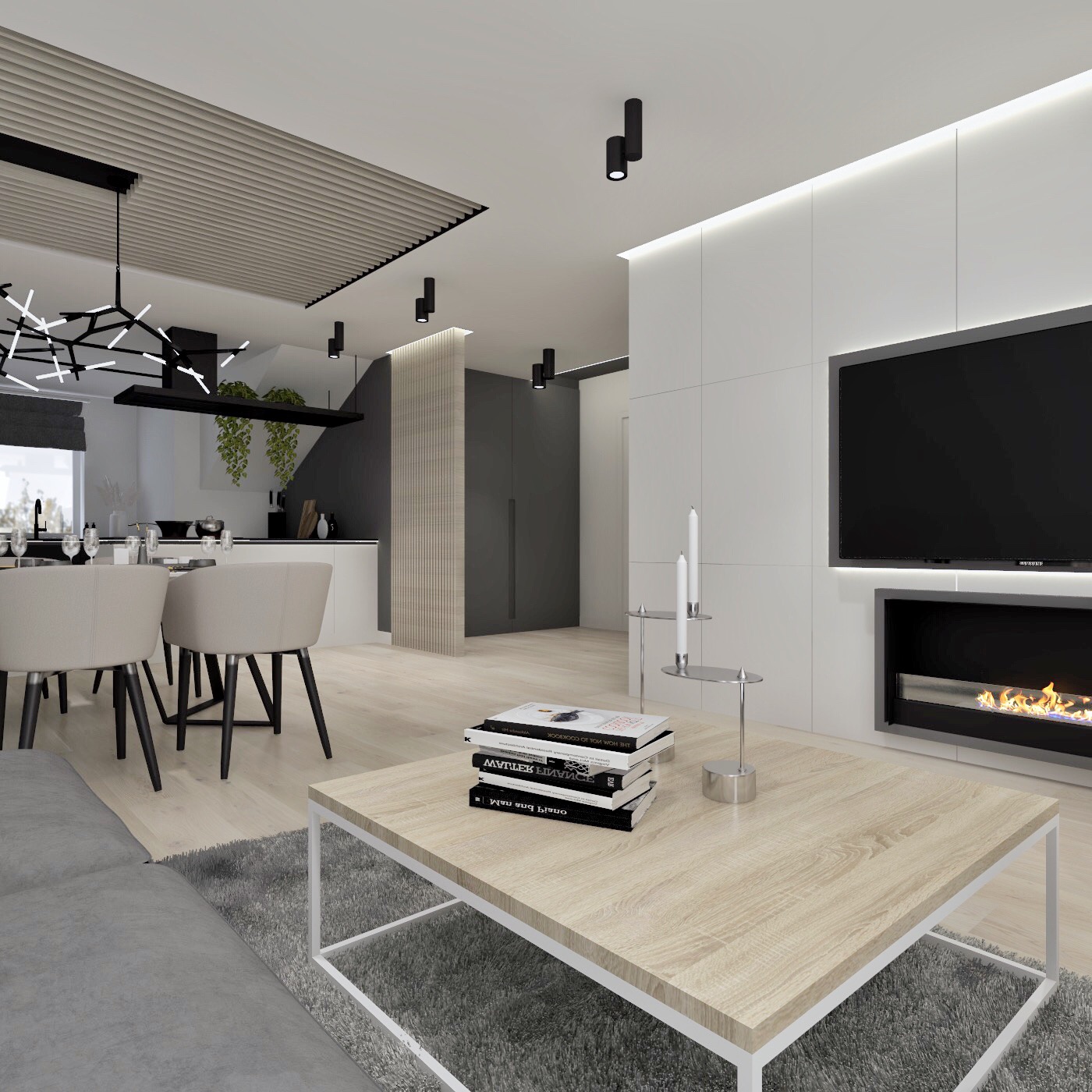 Nowoczesne wnętrze salonu z jadalnią: beżowe krzesła, drewniany stolik kawowy z książkami, telewizor nad kominkiem i designerskie oświetlenie.