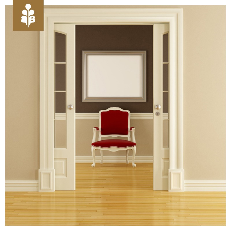 Klasyczne, białe drzwi wewnętrzne z przeszklonymi panelami, otwarte na pokój z czerwonym krzesłem w stylu retro i srebrną ramą na ścianie.