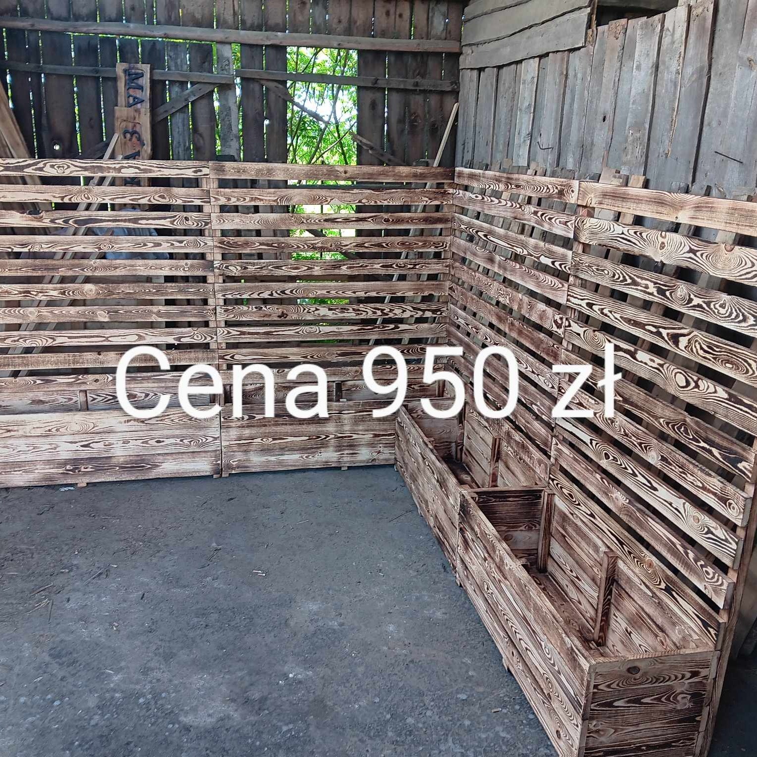 Konstrukcja z opalanych desek, tworząca ściankę działową i donice, cena 950 zł, widoczne słoje drewna.