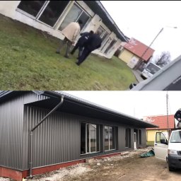 Chrzan-Dach - Nowoczesny budynek z szarej blachy trapezowej, widoczne rynny i obróbki blacharskie, w tle pracownik na dachu i samochód dostawczy.