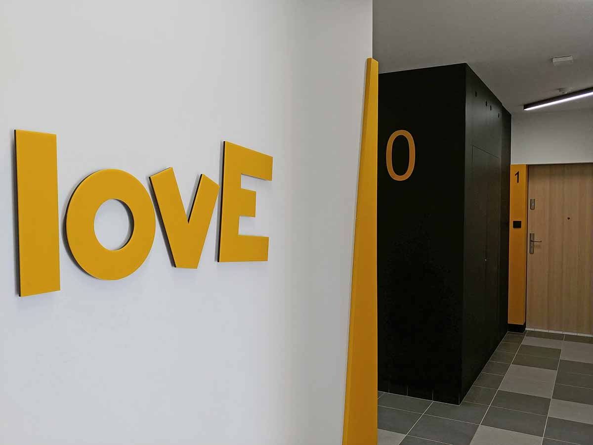 Oznakowanie budynku mieszkalnego: logotypy z plexi, numeracje. Cięcie laserowe