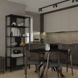 STUDIO ZMIANA - Wizualizacja nowoczesnej kuchni z jadalnią w Gdańsku, z czarnym okrągłym stołem i krzesłami, na tle zabudowy kuchennej w odcieniach szarości i beżu, z widoczną półką z dekoracjami i telewizorem.