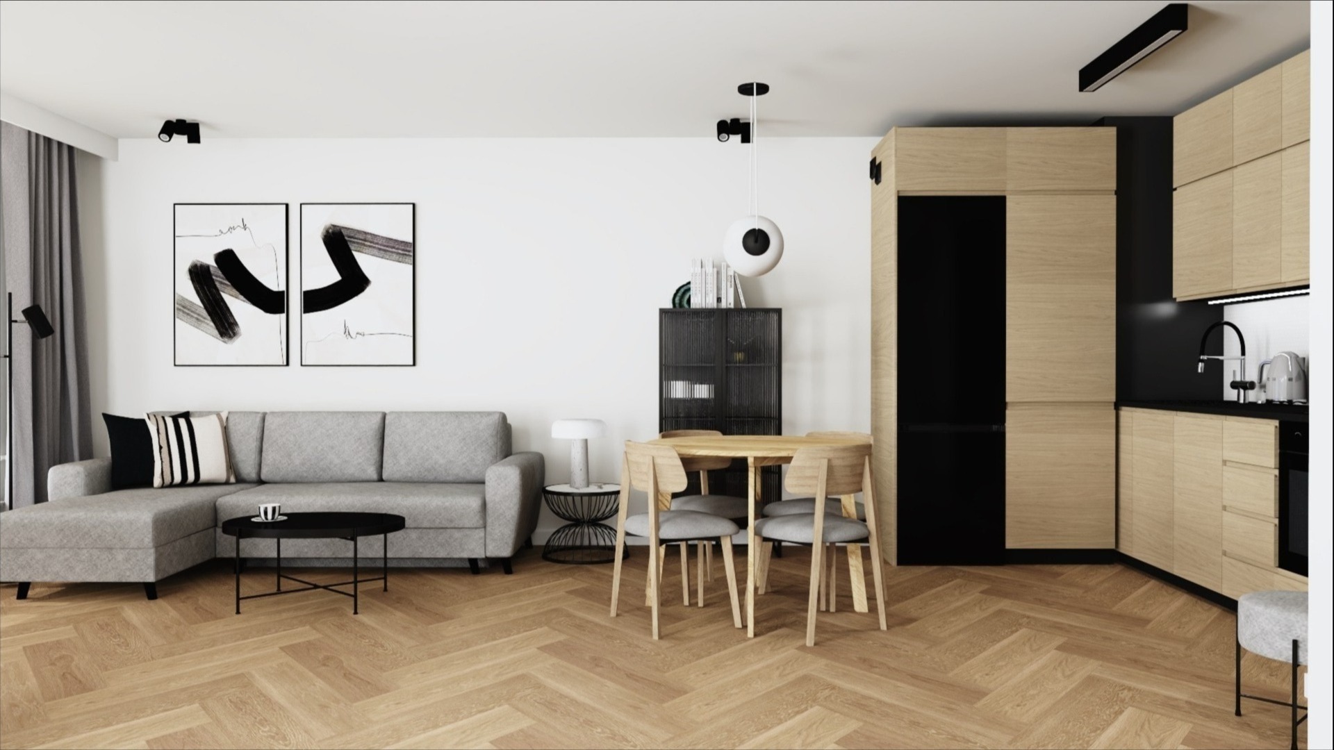 Jasne, nowoczesne wnętrze: szara sofa z czarnymi poduszkami, okrągły stolik kawowy, drewniany stół z krzesłami, zabudowa kuchenna w odcieniach drewna i czerni, parkiet w jodełkę, dekoracje ścienne.